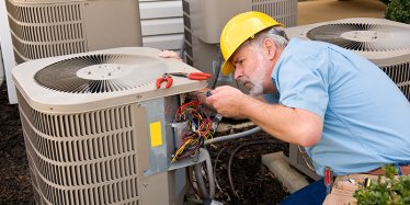 HVAC contractor fixing AC