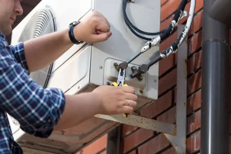 Technician performing AC maintenance in a Horsham PA home
